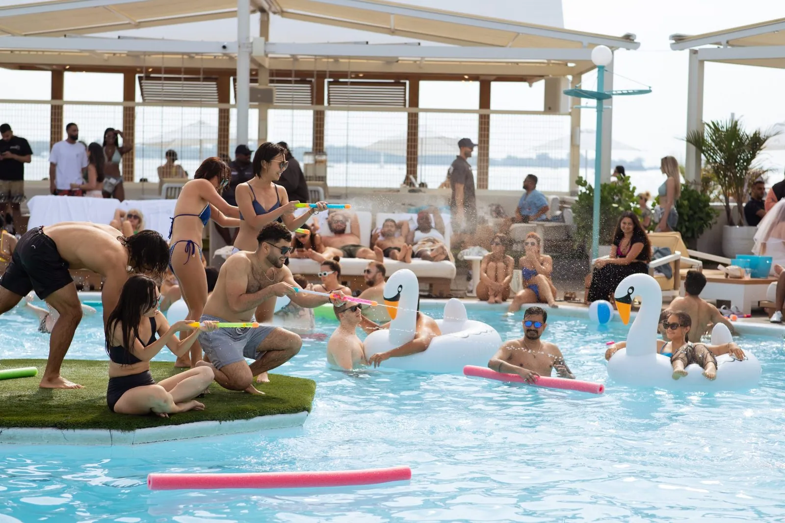 Cabana pool party crowd and skyline